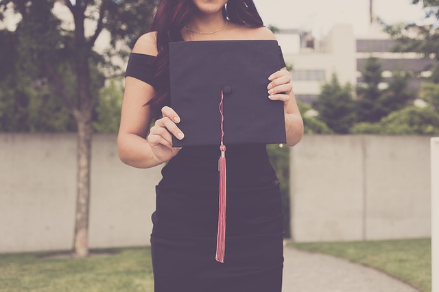 Girl holding a graduation cap